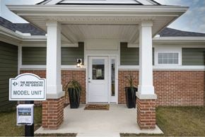 Canton apartment for rent - A house with a sign that says "The Residences at the Greens Model Unit".