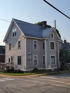 New Glasgow apartment for rent - A two-story house with a grey exterior and a blue roof.