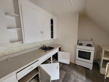 New Glasgow apartment for rent - A kitchen with white cabinets and a marble countertop.