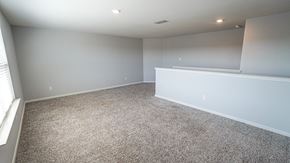 Forney house for rent - A sparsely furnished room with a carpeted floor and white walls.