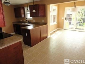 South Euclid house for rent - A kitchen with brown cabinets and a countertop.