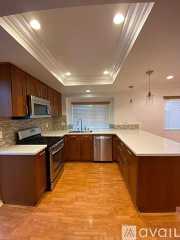 Chino Hills house for rent - A kitchen with wooden cabinets and a white countertop.