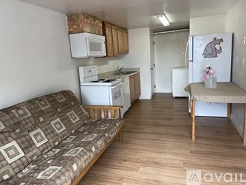 Pullman apartment for rent - A kitchen with a white stove and microwave above it.