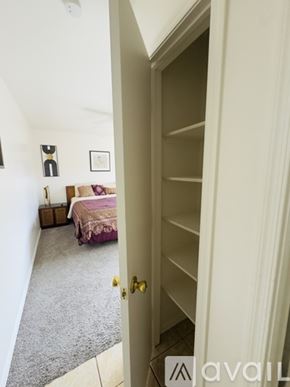 Tucson townhouse for rent - A bedroom with a bed and a dresser is visible through an open door.