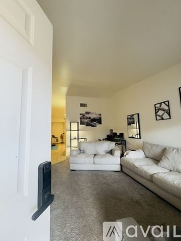 Tucson townhouse for rent - A living room with white furniture and pictures on the wall.