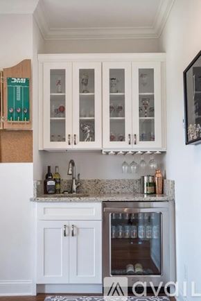 Chattanooga house for rent - A kitchen with white cabinets and a marble countertop.