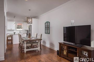 Chattanooga house for rent - A living room with a television and a dining table.