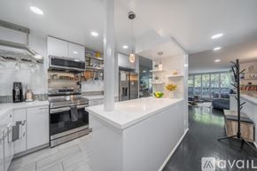 Los Angeles townhouse for rent - A modern kitchen with white cabinets and stainless steel appliances.