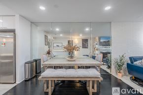 Los Angeles townhouse for rent - A modern dining room with a wooden table and bench.
