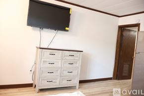 Elroy apartment for rent - A white chest of drawers with a black TV above it.