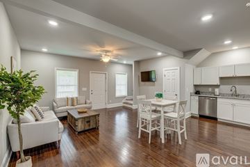 Columbia apartment for rent - A well-lit, spacious kitchen and living room with white furniture and wooden floors.