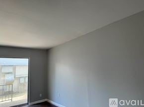 Bryan apartment for rent - A room with a large window and a balcony outside.