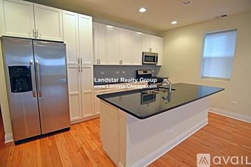 Chicago apartment for rent - A kitchen with a black countertop and stainless steel appliances.