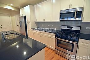 Chicago apartment for rent - A kitchen with a stove, sink, and cabinets.