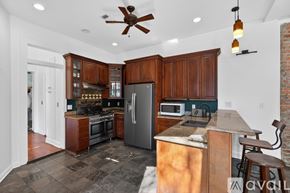 New Orleans apartment for rent - A kitchen with wooden cabinets and a tiled floor.