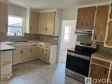 Placerville apartment for rent - A kitchen with wooden cabinets and a black oven.