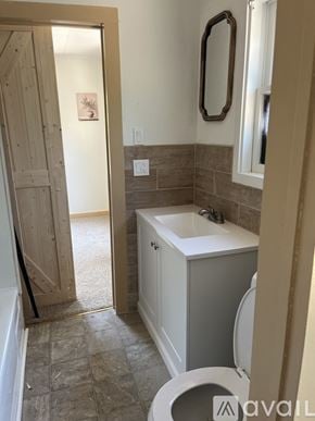Placerville apartment for rent - A bathroom with a toilet, sink, and mirror.
