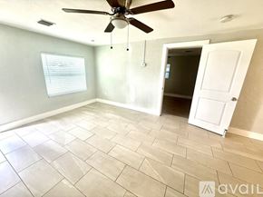 Clearwater house for rent - A kitchen with white cabinets and a stainless steel refrigerator.