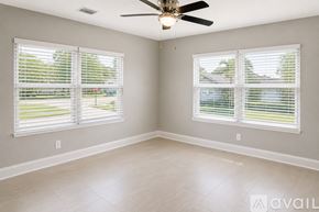 Clearwater house for rent - A bedroom with a large bed and a ceiling fan.