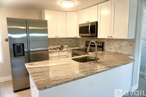 Clearwater house for rent - A bathroom with a walk-in shower and a white sink vanity.