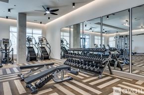 Frisco apartment for rent - A gym with a variety of equipment including treadmills, weights, and a rowing machine.