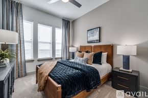 Frisco apartment for rent - A bedroom with a large bed and a ceiling fan.