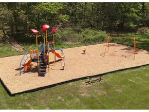 Parma apartment for rent - A playground with a slide, swings, and a sandbox.