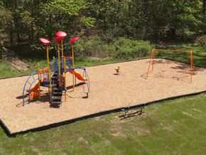 Parma apartment for rent - A playground with a slide, swings, and a sandbox.