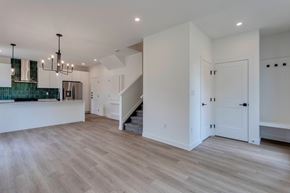 Edmonton apartment for rent - A spacious room with wooden flooring and a staircase.