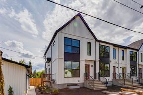 Edmonton apartment for rent - A modern house with a white exterior and a black roof.