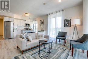 Oshawa (O'neill) condo for rent - A living room with a couch, chairs, and a coffee table.