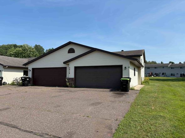 Menomonie apartment for rent - A two-car garage is attached to a house.