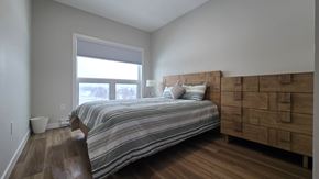 Dryden apartment for rent - A bedroom with a bed, nightstand, and window.