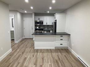Halifax apartment for rent - A kitchen with a black countertop and white cabinets.