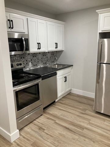 Halifax apartment for rent - A kitchen with white cabinets and a stainless steel refrigerator.