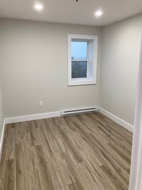 Halifax apartment for rent - A room with a window and a wooden floor.