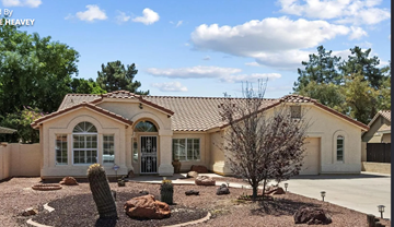 Tempe house for rent - A house with a brown roof and a white wall with a glass window and a door.