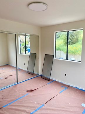 Los Angeles apartment for rent - A room with a pink floor and two windows.