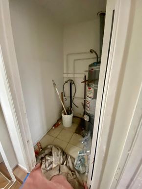 Los Angeles apartment for rent - A dirty kitchen with a white fridge and a white bucket with a brush in it.