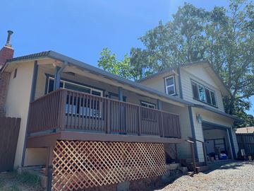 Weaverville house for rent - A house with a brown lattice fence in front.