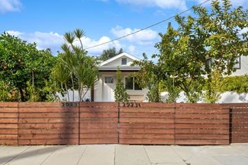 Los Angeles house for rent - A house with a brown fence and trees in front.