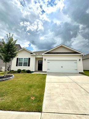 Greer house for rent - A house with a grey roof and a white garage door.