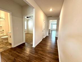 Greer house for rent - A long hallway with wood floors and white walls.