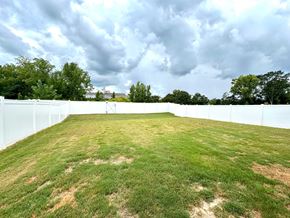 Greer house for rent - A large white fence encloses a grassy field.
