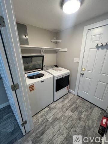 Austin house for rent - A small kitchen with a white oven and microwave.