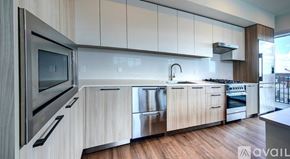 Sarasota townhouse for rent - A modern kitchen with wooden cabinets and stainless steel appliances.