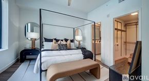 Sarasota townhouse for rent - A modern bedroom with a four poster bed and a bench.
