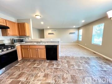 Dexter house for rent - A kitchen with brown cabinets and a tiled floor.