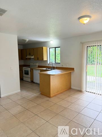 Palm Bay house for rent - A kitchen with a wooden island and white appliances.