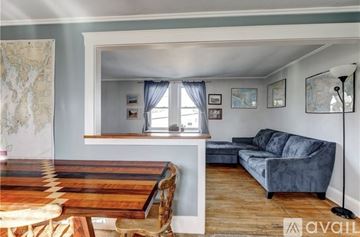 Middletown apartment for rent - A living room with a wooden table and a blue couch.
